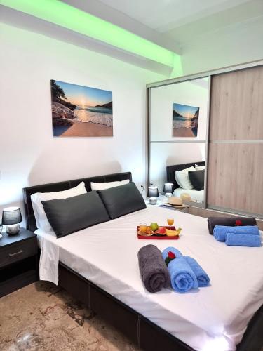 a bedroom with a large bed with towels on it at Luxury Lake - Center House in Agios Nikolaos