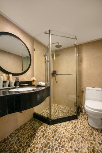 a bathroom with a shower and a sink and a toilet at La Nueva Boutique Hotel Hanoi & Spa in Hanoi