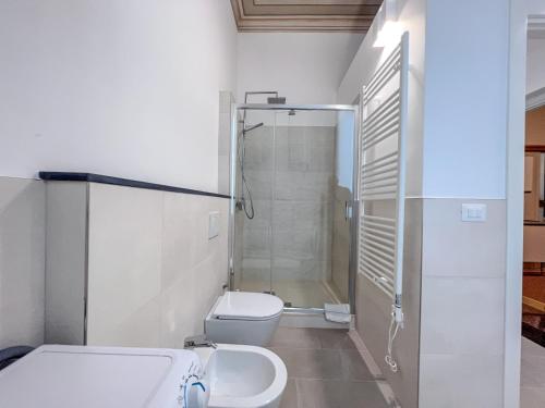 a bathroom with a shower and a toilet and a sink at Appartamenti in Villa del '900 (B) in Varazze