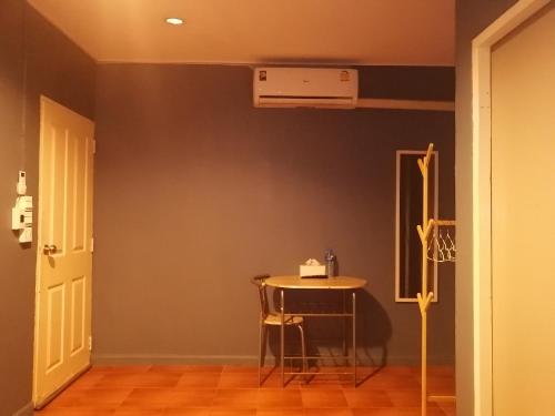 a dining room with a table and a ceiling at airport house in Bangkok