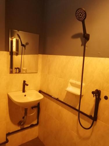 a bathroom with a sink and a shower at airport house in Bangkok
