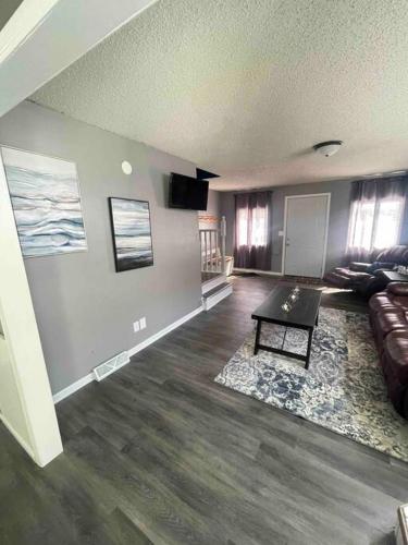 a living room with a couch and a table at Comfortable 2 Bedroom Home in Historic Hibbing in Hibbing