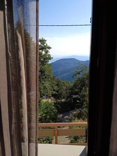 a window with a view of a mountain view at Maro's Guesthouse in Agios Lavredios