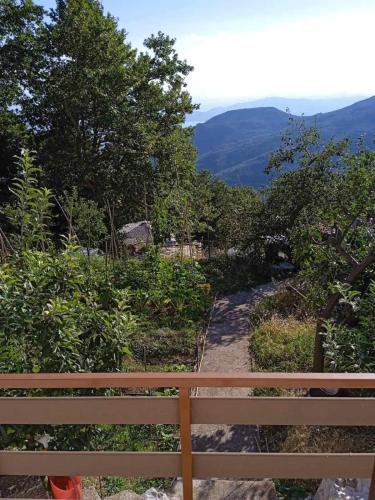 a wooden bench sitting on top of a trail at Maro's Guesthouse in Agios Lavredios