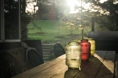 a wooden table with two jars on top of it at Shepherd's Loch Glamping in Turriff