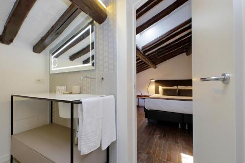 een badkamer met een wastafel en een bed in een kamer bij Youroom Corsini in Rome