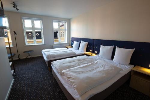Postel nebo postele na pokoji v ubytování Hotel Garni