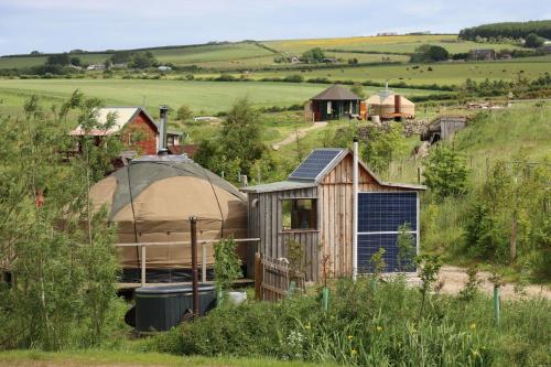 a yurt and a tent in a field at Shepherd's Loch Glamping in Turriff