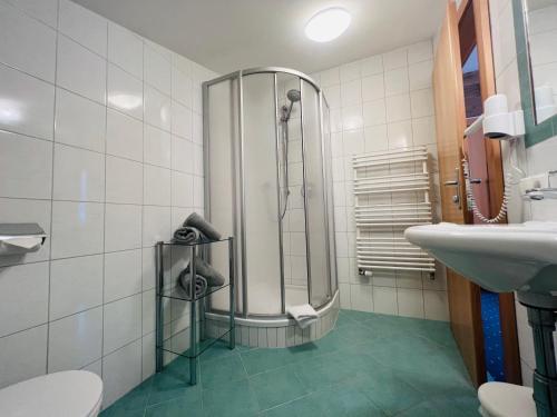 a bathroom with a shower and a sink at Appart Kofler in Gerlos