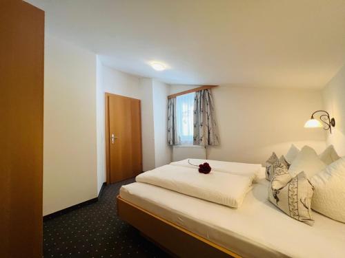 a hotel room with two beds and a window at Appart Kofler in Gerlos