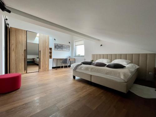 a bedroom with a large bed and a wooden floor at Apartamenty Śleboda in Czarny Dunajec