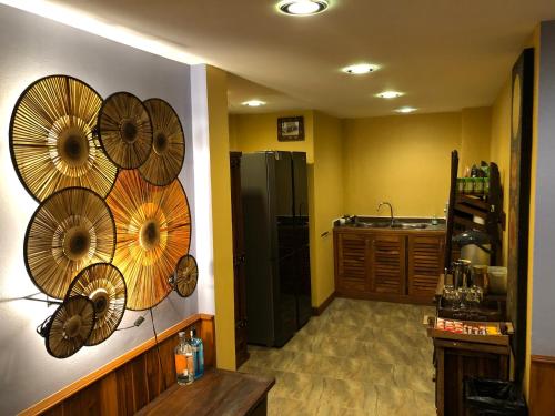 a kitchen with wooden fans on the wall at On The Mekong Resort in Luang Prabang