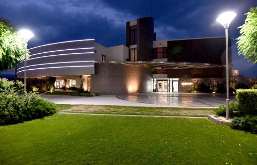 a building at night with a lawn in front of it at Uva Nestum Wine & SPA in Gotse Delchev