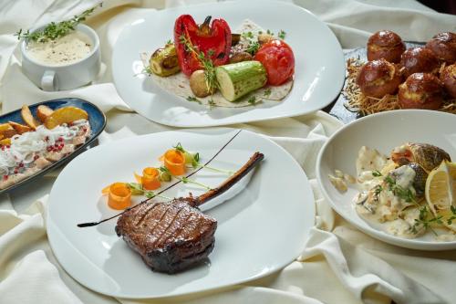 a table with plates of food on it at Дизайн-готель ROAD in Kyiv