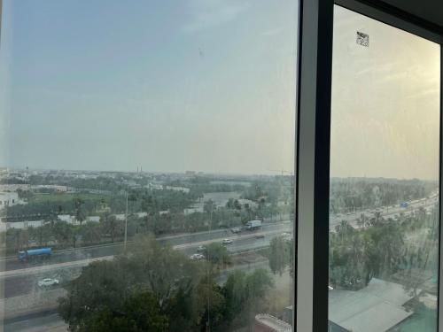 a view of a highway from a glass window at Season Inn Hotel_Al Hail in Seeb