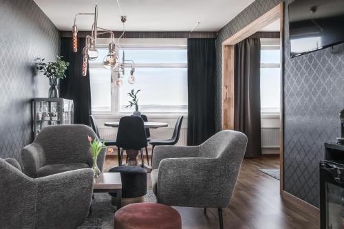 a living room with chairs and a table at Hotell Hallstaberget in Sollefteå