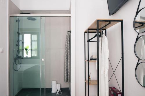 a bathroom with a shower with a glass door at Gateway Suites in Rethymno Town