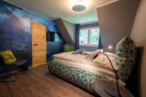 a bedroom with a bed and a chair in it at Vulkan Villa in Mendig