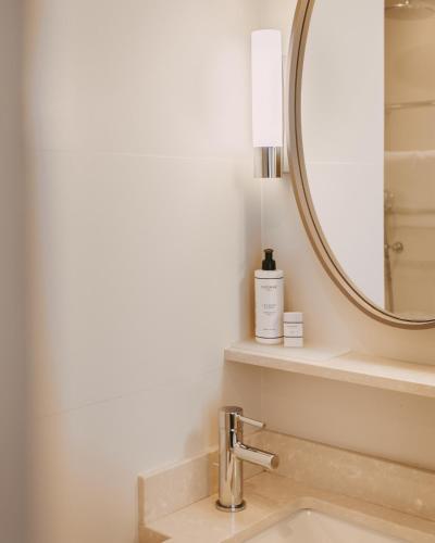a bathroom with a sink and a mirror at Hôtel d'Orsay - Esprit de France in Paris