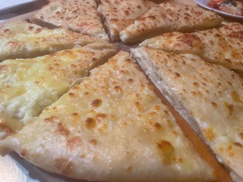 a group of slices of cheese pizza on a plate at Gunter Guest house in Adishi