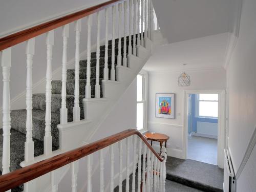a staircase in a home with white walls at 7 Seafield Road in Seaton
