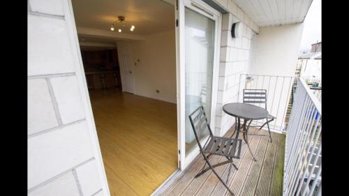 a balcony with a table and chairs and a hallway at Beautiful 3-Bed Apartment in Gourock in Gourock
