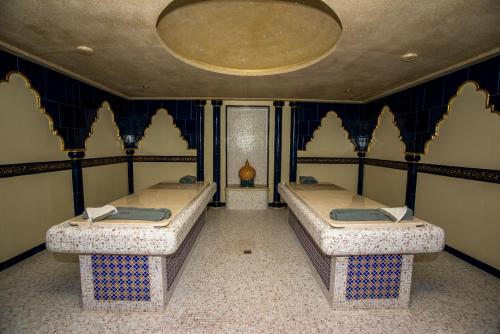 two beds in a room with blue and white walls at Uva Nestum Wine & SPA in Gotse Delchev