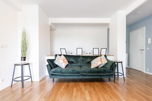 a living room with a green couch at Design 3 bedrooms appartment, near Champs Elysees in Nanterre