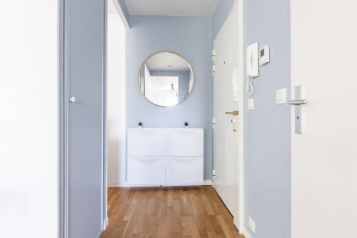 a hallway with a mirror and a white bathroom at Design 3 bedrooms appartment, near Champs Elysees in Nanterre
