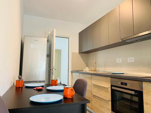 a kitchen with a table with two plates on it at Newton luxury apartment in Iaşi