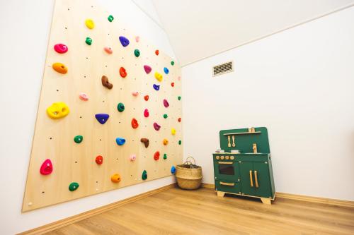 a rock wall in a room with a climbing wall at SAUNA FOREST CABIN 軽井沢 御代田 A棟 zen-asobi in Oiwake