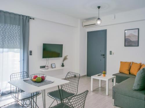a living room with a table and chairs and a couch at ChriLenia Aparments in Kalamata