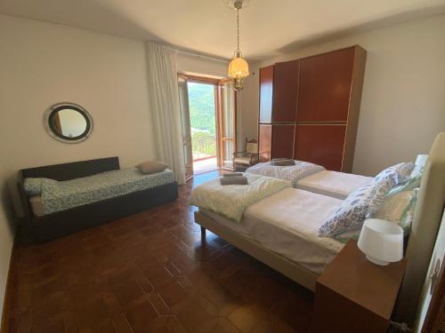 a bedroom with a large bed and a window at B&B Rox e Claudia in Lugnola