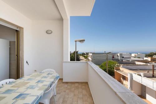 a balcony with tables and a view of the ocean at Casa vacanza Mare Blu in Torre Lapillo