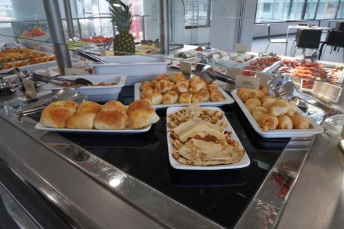 a buffet line with trays of pastries and other foods at Uva Nestum Wine & SPA in Gotse Delchev