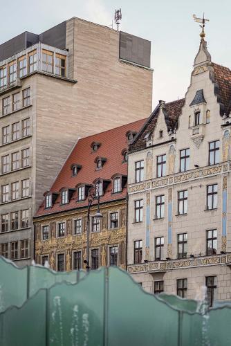a large building in front of a building at Great Polonia The Granary La Suite Hotel in Wrocław