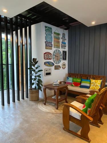a living room with a couch and a table at Bakawan Hostel in Coron