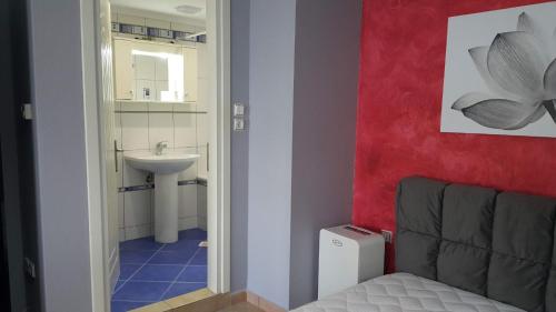 a bathroom with a sink and a chair in a room at HOPE HOUSE in Kavála