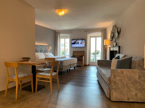 a living room with a couch and a table at Albergo Ristorante Montebaldo in Limone sul Garda