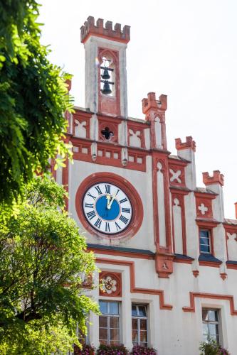 a clock tower on the side of a building at Hotel-Gasthof Zur Post in Velburg