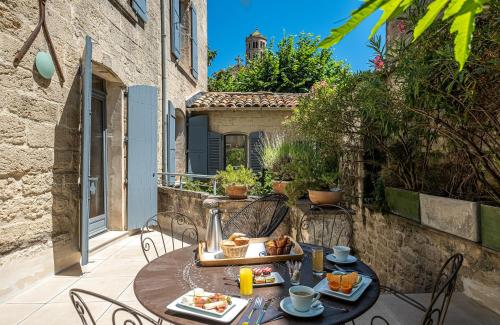 a table with food on it on a patio at Boutique Hôtel Entraigues in Uzès