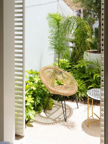 a wicker chair and table on a patio at The Standard, Ibiza in Ibiza Town