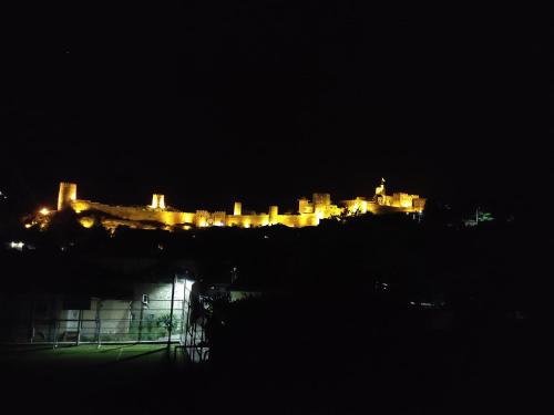 a city lit up at night with a castle at Zukas Hause in Akhaltsikhe