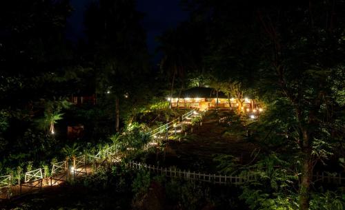 a garden lit up at night with lights at Lotus an Eco Beach Resort Dapoli Murud in Dapoli