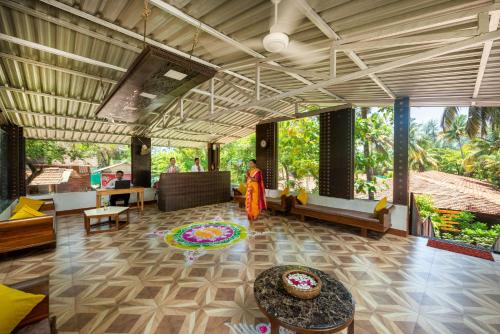 a large living room with a person standing in a room at Lotus an Eco Beach Resort Dapoli Murud in Dapoli