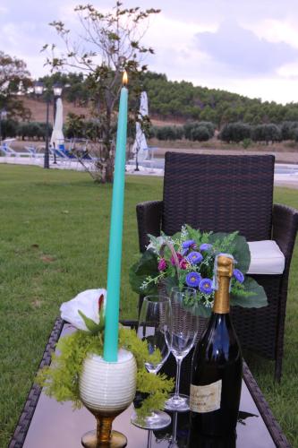 a table with a candle and a bottle of wine at Agriturismo Fieri in Botricello