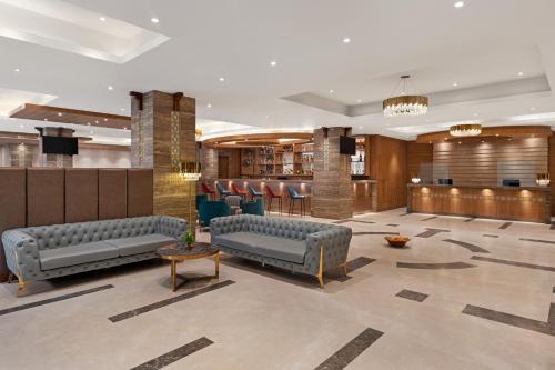 a lobby with couches and a bar in a hotel at Ramada Encore by Wyndham Kathmandu Thamel in Kathmandu
