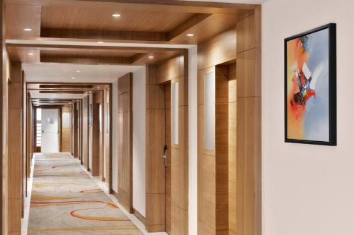 a hallway with wooden doors and a painting on the wall at Ramada Encore by Wyndham Kathmandu Thamel in Kathmandu
