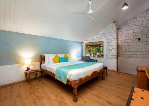 a bedroom with a large bed in a room at Lotus an Eco Beach Resort Dapoli Murud in Dapoli