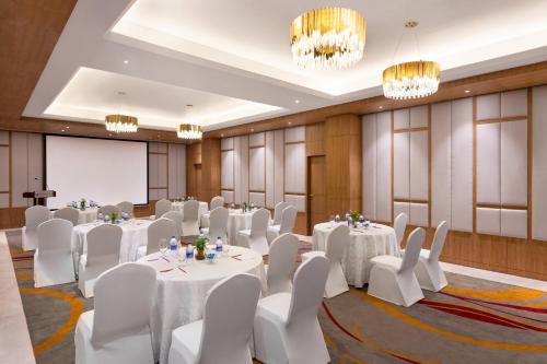 a conference room with white tables and white chairs at Ramada Encore by Wyndham Kathmandu Thamel in Kathmandu